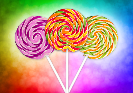 three lolly pops in front of colorful backgroundの写真素材