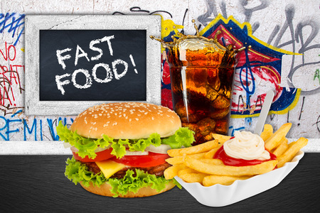 Fast food meal in front of graffiti wallの写真素材
