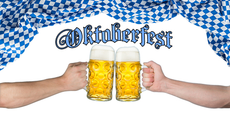 cheers! hands holding up german beer mugs under bavarian flagの写真素材