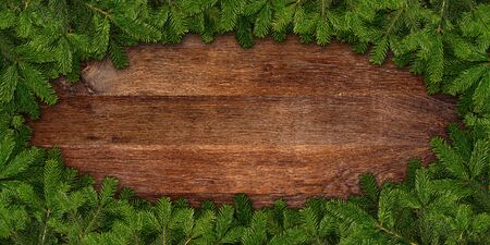 fir branches frame on wooden backgroundの写真素材
