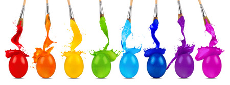 colorful rainbow easter egg color splash row with paintbrushesの写真素材
