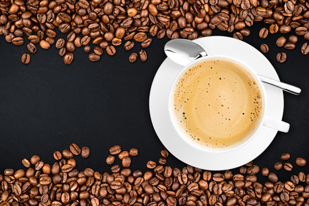 coffee cup and beans on rustic slate backgroundの写真素材