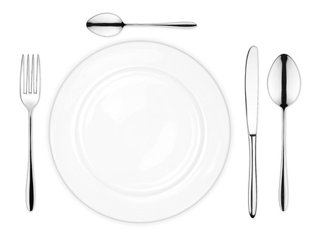 place setting with empty dish fork spoon and knife isolated on white backgroundの写真素材