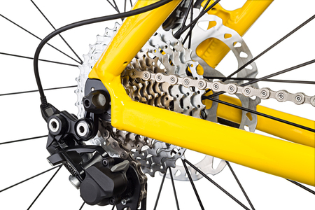 derailleur mechanism closeup on a yellow mountain bike isolated on white backgroundの写真素材