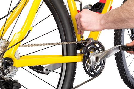 bicycle mechanic working on yellow mountain bikeの写真素材