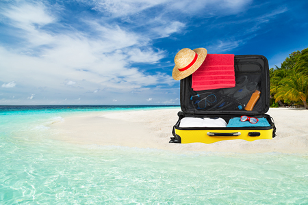suitcase on paradise beach with crystall clear oceanの写真素材