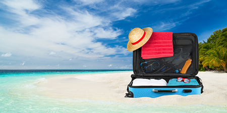 suitcase on paradise beach with crystall clear oceanの写真素材