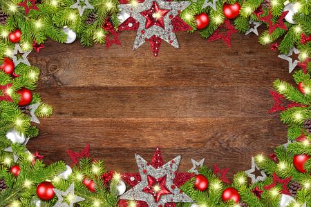 christmas xmas old rustic oak wood background with decoration baubles stars pine cones berry decorated fir branchesの写真素材