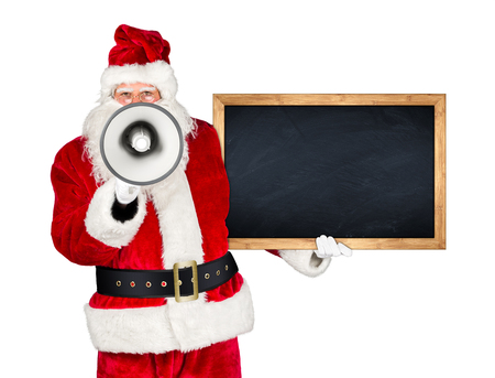 traditional classic red white santa claus making shouting loud announcement with bullhorn megaphone wooden blackboard in his other hand isolated on white backgroundの写真素材