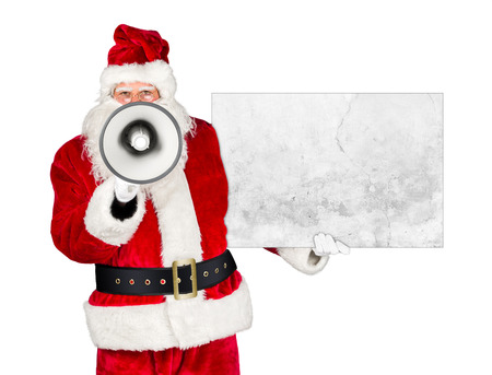 traditional classic red white santa claus making shouting loud announcement with bullhorn megaphone concrete stone billboard in his other hand isolated on white backgroundの写真素材