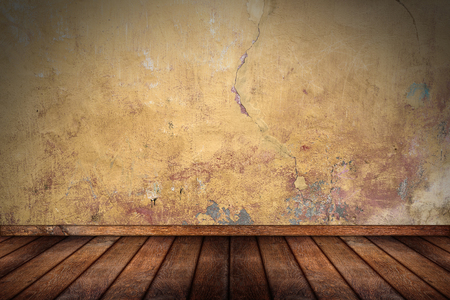 empty pattern room with wooden oak floor and orange yellow grunge concrete stone wallの写真素材