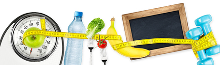 fitness diet motivation panorama  background concept water bottle apple banana salad tomatoe bathroom scale measuring tape and empty blackboard isolated on white backgroundの写真素材
