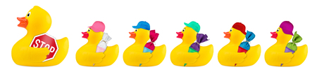 yellow classic rubber bath duck toy road safety school crossing guard concept row isolated on white backgroundの写真素材