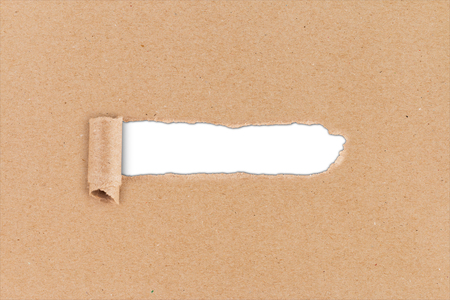 think outside the box business concept ripped hole in brown paper on white backgroundの写真素材