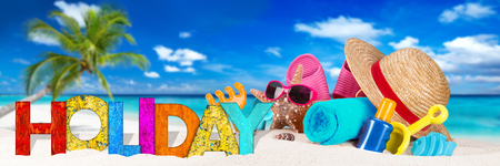 holiday lettering and beach supplies accessory on sand in front of coco palm on tropical paradise island dream beachの写真素材