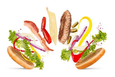 hamburger cheeseburger explosion concept flying ingredients isolated on white backgroundの写真素材