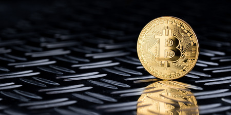 golden bitcoin crypto currency symbol coin on silver diamond steel plate wide financial panorama black backgroundの写真素材