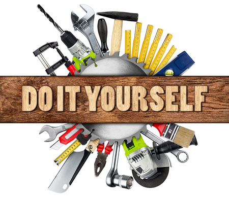 DIY tools collage concept behind wooden plank with copy space and circular saw blade isolated on white backgroundの写真素材