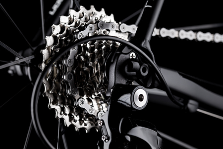 bicycle bike rear derailleur gear casette chain detail close up shot black dark background