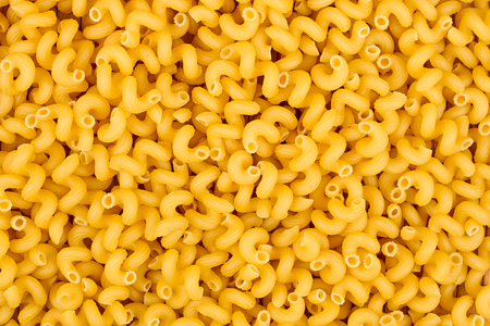 texture of raw Cavatappi Cellentani noodles pasta italian food macro close-up backgroundの写真素材
