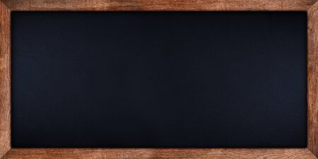 wide panorama dark stone slate blackboard or chalkboard with rustic wooden oak wood frame empty with copy space. school education study concept background.の写真素材
