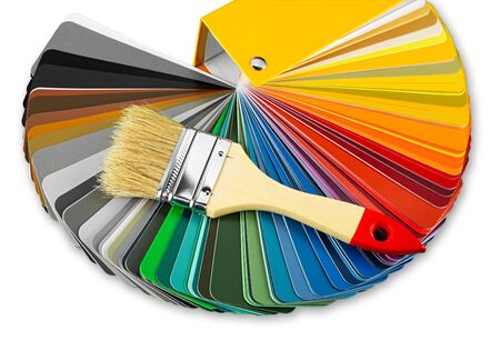 Color guide fan chart catalog spectrum of all kind of various colors to choose paint from book brush on it. DIY renovation home improvement print  concept with paintbrush isolated  on white backgroundの写真素材