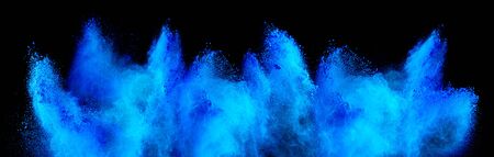 cyan blue holi paint color powder explosion isolated on dark black background. industry beautiful party festival conceptの写真素材