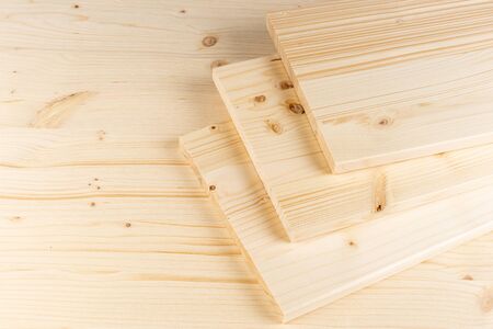 stack of spruce wood construction planks or boards on wooden background. Natural material carpentry diy industry furniture making concept.の写真素材