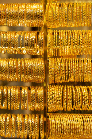 many golden jewel bracelet ring made of pure gold on jeweler display backgroundの写真素材