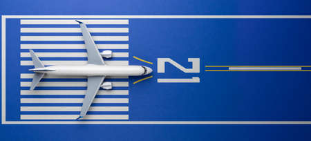 Top view of white commercial passenger airline airplane jet on runway ready for takeoff blue background. Transportation tourism travel aviation and business concept.の写真素材