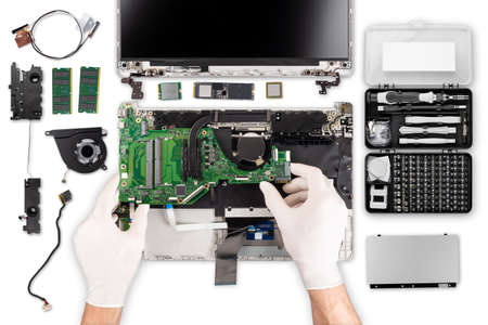 technician with gloves chainging fix motherboard repair in top view. isolated on white background. computer parts and hand tools on work desk.の写真素材