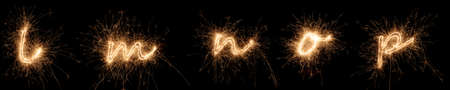 golden bright sparkler alphabet font letter set collection part L to P isolated on dark black background. new year's eve birthday and celebration design patternの写真素材