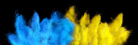 colorful ukrainian flag yellow blue color holi paint powder explosion isolated on black background. russia ukraine conflict war freedom conceptの写真素材