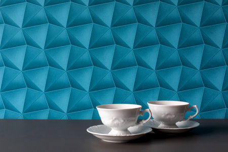 A background with blue wallpaper - colorful space. Coffee for Two: White Cups for a Couple. Elegant Coffee: Two White, Simple Cups.の写真素材