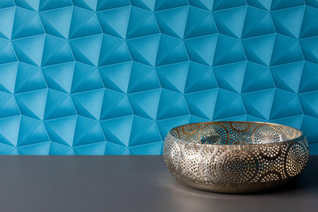 A background with blue wallpaper - colorful space. A silver tray as a decoration for an apartment. A fruit platter in an elegant style.の写真素材