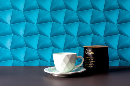 A background with blue wallpaper - colorful space. Morning coffee in an elegant style. Coffee on the table - minimalist accessories. White cups and coffee container - simplicity in an elegant style.の写真素材