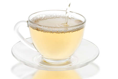 green tea pouring into glass cupの写真素材