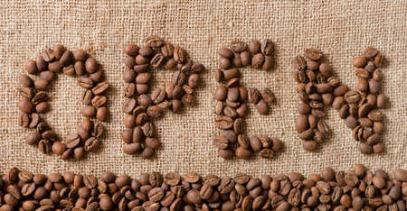 The word Open from coffee beans on linea material の写真素材