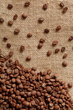 Coffee beans on burlap backgroundの写真素材