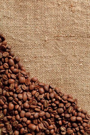 Coffee beans on burlap backgroundの写真素材
