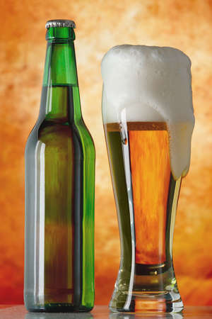 Bottle glass of beer on a yellow backgroundの写真素材