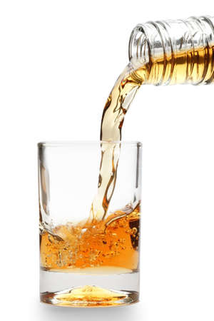 whiskey being poured into a glass の写真素材