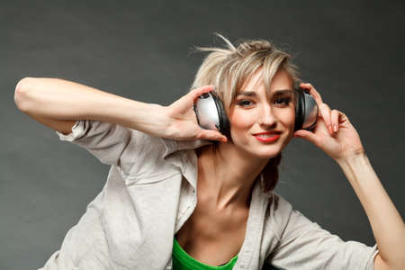 Young girl listening to music by headphonesの写真素材