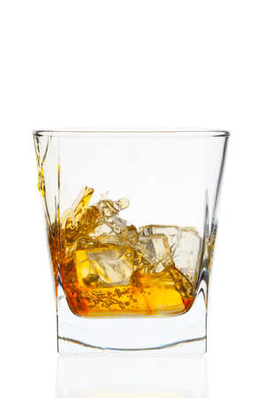 Whiskey glass. Isolated on white with reflectionの写真素材