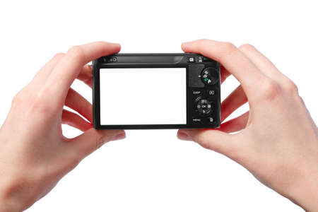 Closeup image of two hands black compact digital photo camera with empty display for your picture or textの写真素材