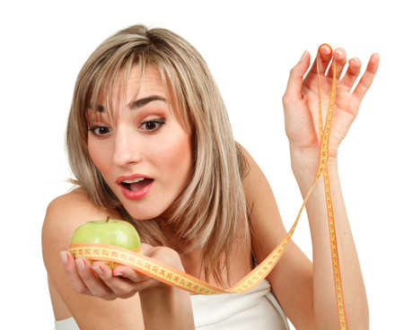 Beautiful woman measuring her waist, white background の写真素材