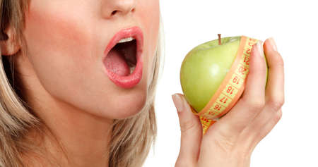 woman holding an apple on a white backgroundの写真素材