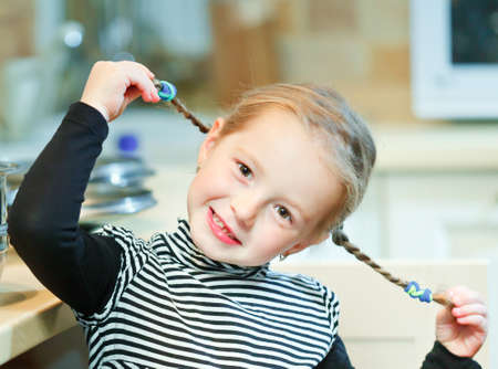 child holds pigtailsの写真素材