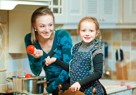 Happy woman and child preparing healthy food togetherの写真素材