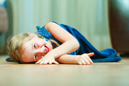 Close up of smiling girl on the floorの写真素材